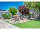 Backyard featuring synthetic grass, a firepit, and a bench seating area at 6236 Foothill Blvd, Las Vegas, NV 89118