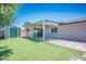 Backyard featuring a storage shed, synthetic grass, and covered patio at 6236 Foothill Blvd, Las Vegas, NV 89118