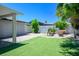 Backyard featuring synthetic grass, a fire pit, and covered outdoor seating at 6236 Foothill Blvd, Las Vegas, NV 89118