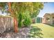 Backyard featuring a storage shed, synthetic grass, and block wall fence at 6236 Foothill Blvd, Las Vegas, NV 89118