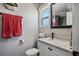 Well-lit bathroom with a granite countertop, a stylish mirror and a window for natural light at 6236 Foothill Blvd, Las Vegas, NV 89118