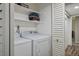 Cozy laundry area featuring a washer, dryer, and built-in shelving for storage at 6236 Foothill Blvd, Las Vegas, NV 89118