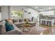 An open-concept living room with hardwood floors, a large sectional, and a view into the kitchen at 6236 Foothill Blvd, Las Vegas, NV 89118