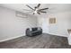 Living room with a modern ceiling fan, gray walls and floors, and a comfy gray sofa at 6236 Foothill Blvd, Las Vegas, NV 89118