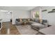 Spacious living room featuring hardwood floors and a large gray sectional with throw pillows at 6236 Foothill Blvd, Las Vegas, NV 89118