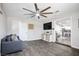 Living room with a view into the kitchen, featuring a modern ceiling fan and gray floors at 6236 Foothill Blvd, Las Vegas, NV 89118