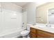 Full bathroom showcasing a single sink vanity, toilet, and shower over tub combo with white tile at 6548 Butterfly Sky St, North Las Vegas, NV 89084