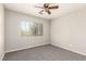 Bedroom featuring a window, carpeted floors, neutral walls, and a modern ceiling fan with light at 6548 Butterfly Sky St, North Las Vegas, NV 89084