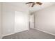 Bedroom featuring neutral walls, carpeted floor, ceiling fan and a closet with sliding doors at 6548 Butterfly Sky St, North Las Vegas, NV 89084