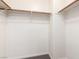 Walk-in closet with neutral-toned walls and carpet offering ample storage and organization space at 6548 Butterfly Sky St, North Las Vegas, NV 89084