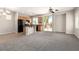 Open-concept kitchen with an island, adjacent to spacious living area at 6548 Butterfly Sky St, North Las Vegas, NV 89084