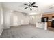 Spacious open-plan living area featuring a kitchen island and modern ceiling fan at 6548 Butterfly Sky St, North Las Vegas, NV 89084