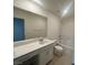 Bright bathroom featuring a sleek vanity with ample counter space and a bathtub/shower combination with white tile at 6604 Bowery St, Las Vegas, NV 89148