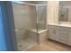 Modern bathroom featuring a sleek glass-enclosed shower with a built-in bench and updated vanity at 6604 Bowery St, Las Vegas, NV 89148
