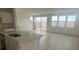 Modern kitchen showcasing white cabinetry, stainless steel sink, and sliding door access to the patio at 6604 Bowery St, Las Vegas, NV 89148