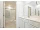 Bathroom featuring a single sink vanity, toilet, and shower with glass doors at 675 Omaggio Pl, Henderson, NV 89011