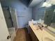 Well-lit bathroom features a double vanity and shower with glass door at 7905 Ryandale Cir # 201, Las Vegas, NV 89145