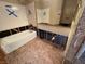 Unfinished bathroom featuring new white tub and white tile at 7905 Ryandale Cir # 201, Las Vegas, NV 89145