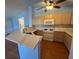 Modern kitchen with bright countertops, wood cabinets, and modern appliances at 7905 Ryandale Cir # 201, Las Vegas, NV 89145