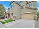 Front elevation of a two-story home featuring a two-car garage, stone accents, and manicured lawn at 8335 Martinborough Ave, Las Vegas, NV 89131