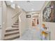 Inviting foyer with tiled floors, staircase, and decorative accents at 8335 Martinborough Ave, Las Vegas, NV 89131