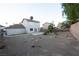Backyard has minimal landscaping, desert foliage, small concrete patio, and a perimeter fence at 860 Bergamont Dr, Henderson, NV 89002