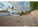 Wide view of the spacious backyard featuring rocks and desert landscaping in place of grass at 860 Bergamont Dr, Henderson, NV 89002