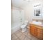 Bright bathroom with tiled floor, shower-tub combination, wood cabinet and updated sink at 860 Bergamont Dr, Henderson, NV 89002