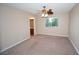 Spacious bedroom with ceiling fan, carpeted floor and ensuite bathroom at 860 Bergamont Dr, Henderson, NV 89002