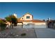 Charming two-story home featuring a manicured lawn, mature trees and a convenient two-car garage at 860 Bergamont Dr, Henderson, NV 89002