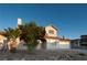 Inviting two-story home featuring mature landscaping, a well-maintained lawn, and an attached two-car garage at 860 Bergamont Dr, Henderson, NV 89002