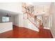 Welcoming foyer features an open layout, wood floors, and a staircase leading to the upper level at 860 Bergamont Dr, Henderson, NV 89002