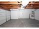 Garage featuring a concrete floor, an insulated garage door, and a hot water heater at 860 Bergamont Dr, Henderson, NV 89002