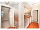 Hallway with wooden floors, white staircase, and rooms leading off of it at 860 Bergamont Dr, Henderson, NV 89002