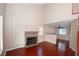 Spacious living room featuring a fireplace, soaring ceilings, and gleaming wood floors for a cozy ambiance at 860 Bergamont Dr, Henderson, NV 89002