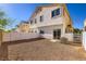 Rear exterior featuring a rock ground cover, and a rear building view with a fence at 8842 Duncan Barrel Ave # 103, Las Vegas, NV 89178