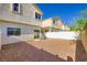 Exterior backyard featuring rock ground cover, and a rear building view with a fence at 8842 Duncan Barrel Ave # 103, Las Vegas, NV 89178