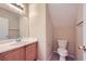 Cozy half bathroom features a single vanity with wood cabinets and neutral wall color at 8842 Duncan Barrel Ave # 103, Las Vegas, NV 89178