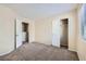 Bright bedroom featuring neutral colors, modern carpet, and a closet for storage at 8842 Duncan Barrel Ave # 103, Las Vegas, NV 89178