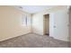 Cozy bedroom featuring plush carpet, bright window, and closet with sliding doors at 8842 Duncan Barrel Ave # 103, Las Vegas, NV 89178
