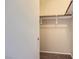 Walk in closet with wood shelving and neutral walls in a new home at 8842 Duncan Barrel Ave # 103, Las Vegas, NV 89178