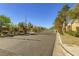A view of the gated entrance to the community, surrounded by lush landscaping on a sunny day at 8842 Duncan Barrel Ave # 103, Las Vegas, NV 89178
