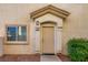 Close up of the front door and entryway with a small window and landscape at 8842 Duncan Barrel Ave # 103, Las Vegas, NV 89178