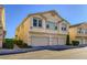Three-story townhouse featuring a three-car garage and a neutral stucco exterior at 8842 Duncan Barrel Ave # 103, Las Vegas, NV 89178