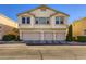 Exterior of a three-story townhouse featuring a three-car garage at 8842 Duncan Barrel Ave # 103, Las Vegas, NV 89178