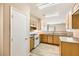 Bright kitchen features wood cabinets, gas range, and durable countertops at 8842 Duncan Barrel Ave # 103, Las Vegas, NV 89178