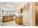 Open-concept kitchen featuring oak cabinets and granite counters with views of the living area at 8842 Duncan Barrel Ave # 103, Las Vegas, NV 89178