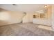 Open-concept living room and staircase featuring neutral carpet and paint at 8842 Duncan Barrel Ave # 103, Las Vegas, NV 89178