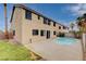 Two-story home with a private backyard featuring a pool, patio area, and lush landscaping at 108 Parker Ranch Dr, Henderson, NV 89012