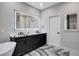 Modern bathroom with dual sinks, a large mirror, a soaking tub, and black accents at 108 Parker Ranch Dr, Henderson, NV 89012